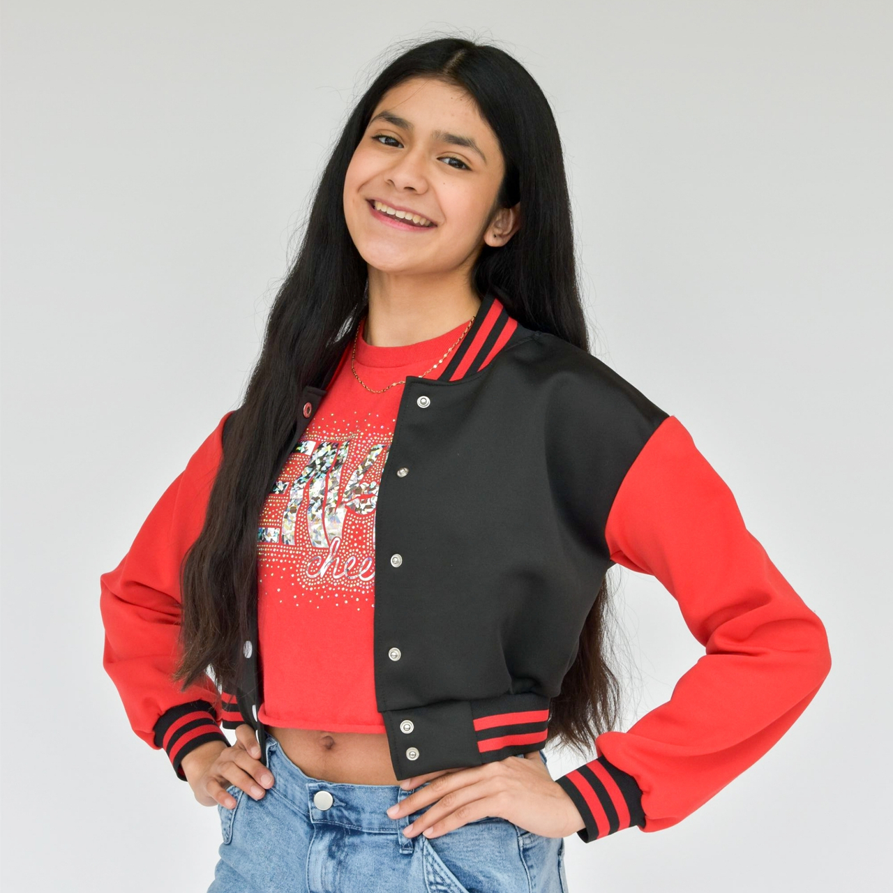 Portrait of a young girl wearing a black jacket with red sleeves